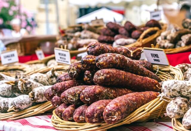 Artisan sausages in baskets at a market in France