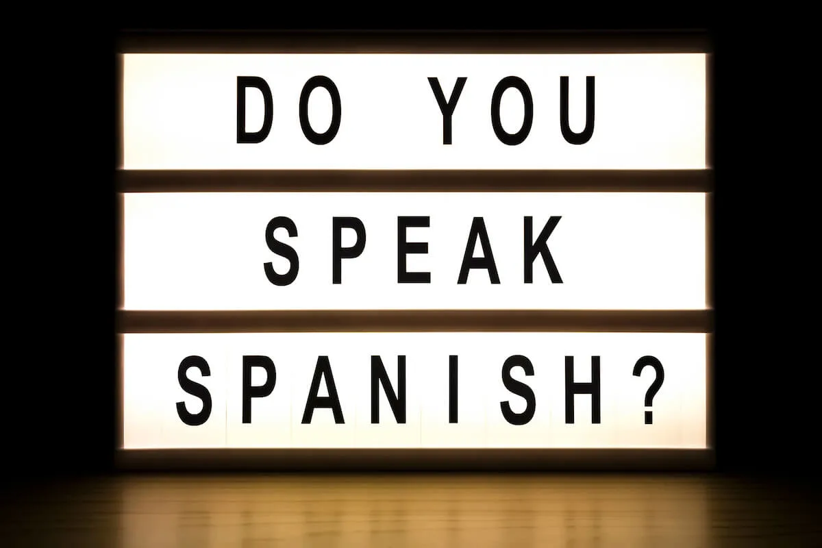 Basic Spanish Words for Travel cover photo of a white light box with black letters with the words 'do you speak Spanish?'
