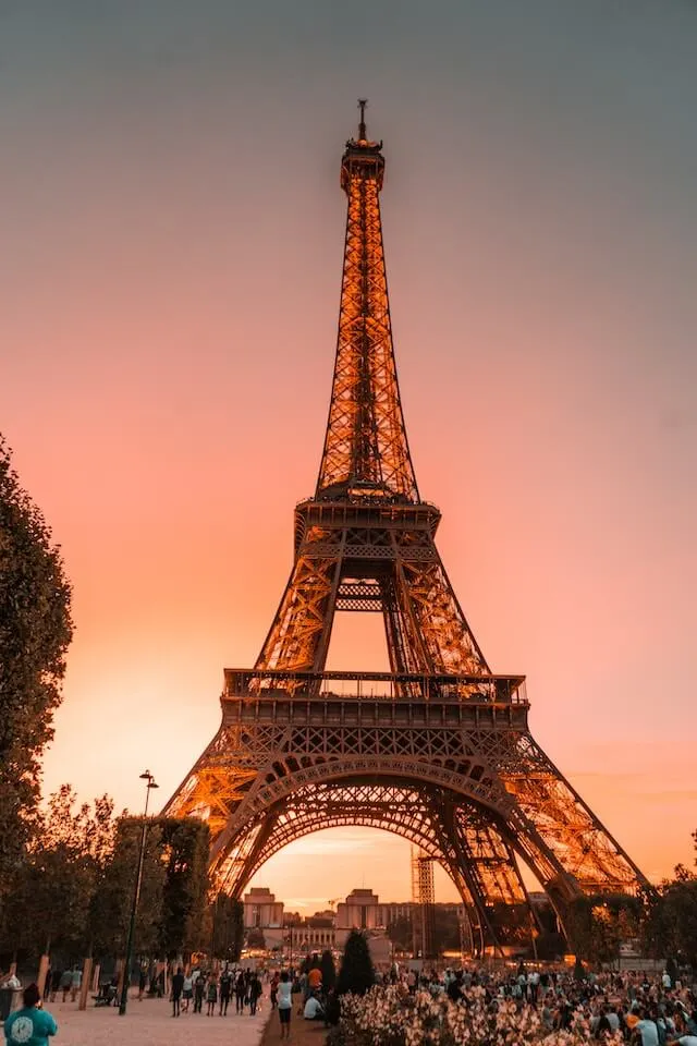 Eiffel Tower at sunset, bathed in orange light