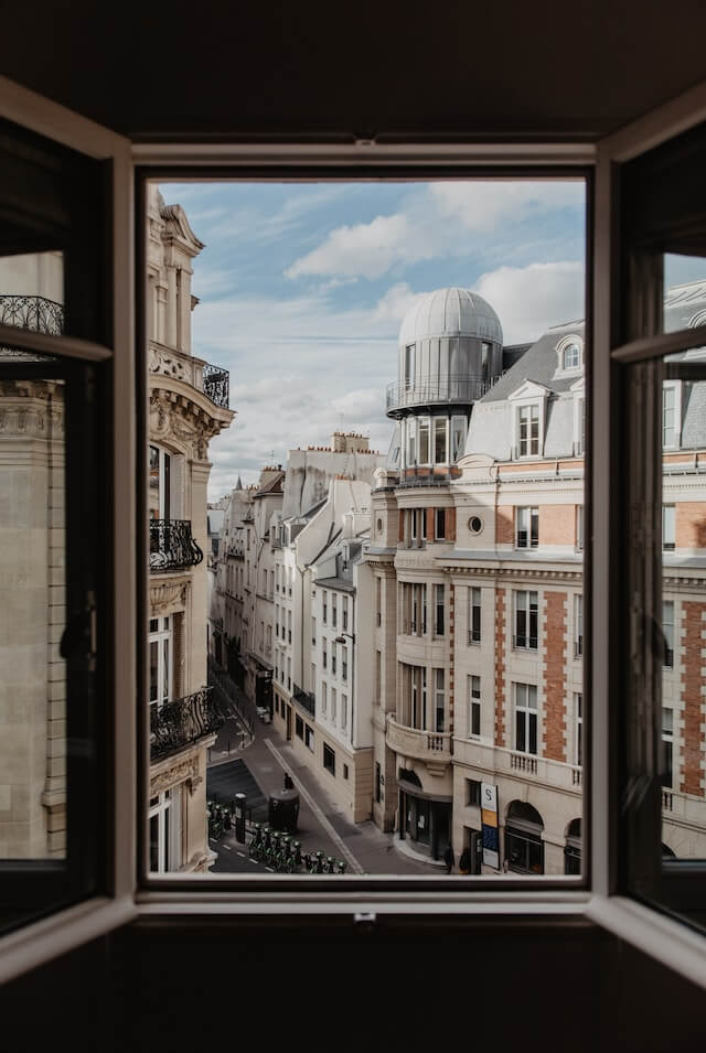 View out of an open window of a hotel in Paris