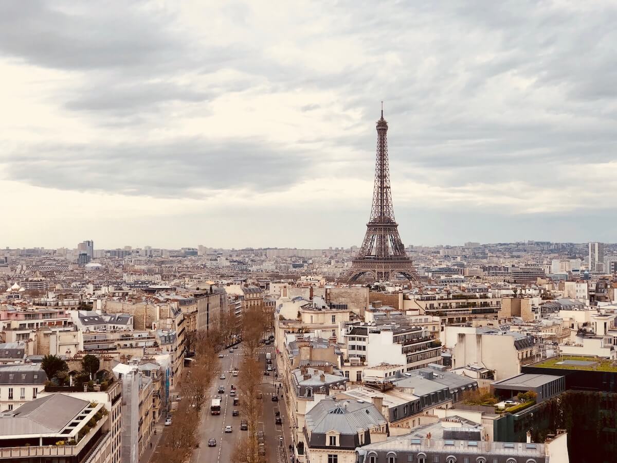 Paris Travel Tips (Perfect for First Time Visitors) cover photo of the view above the city of Paris taken from the Arc de Triomphe 