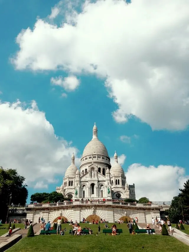 Sacre Coeur Bascilica under a blue sky with white clouds