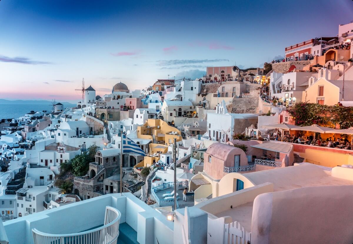 Things to do in Santorini Greece cover photo of Oia at suset