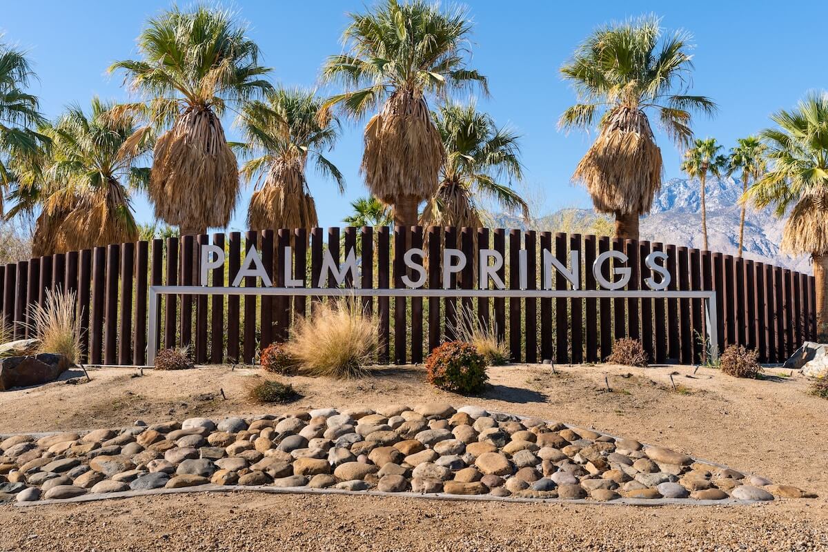Things to do in Palm Springs California cover photo of the Palm Springs sign in front of several palm trees