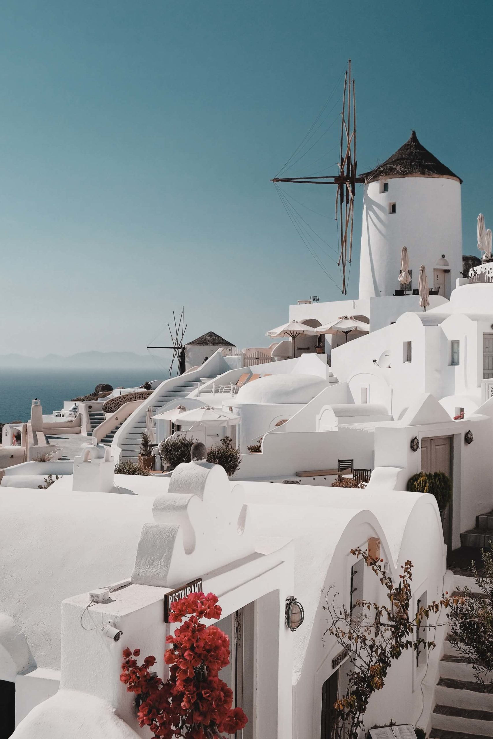 Whitewashed buildings and windmills on The Best Greek Islands for Couples, the most romatic greek islands.