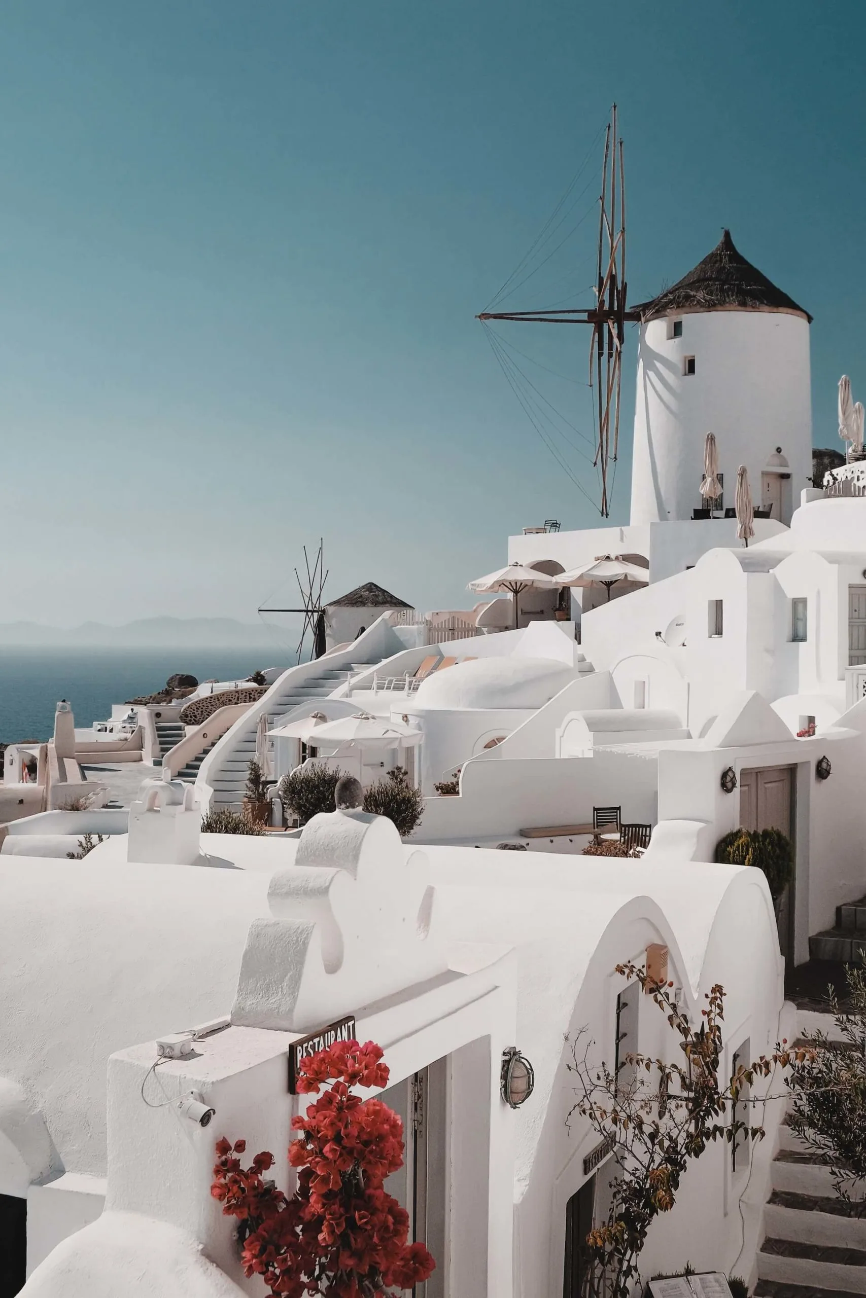 Whitewashed buildings and windmills on The Best Greek Islands for Couples, the most romatic greek islands.