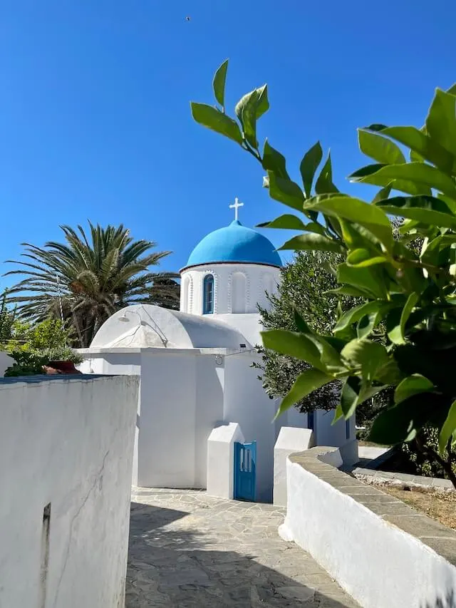 White building with blue domed roof in Milos Greece