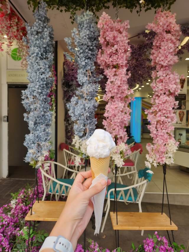 Ice Cream shop with flowe garlands hanging above wooden swings in Athens